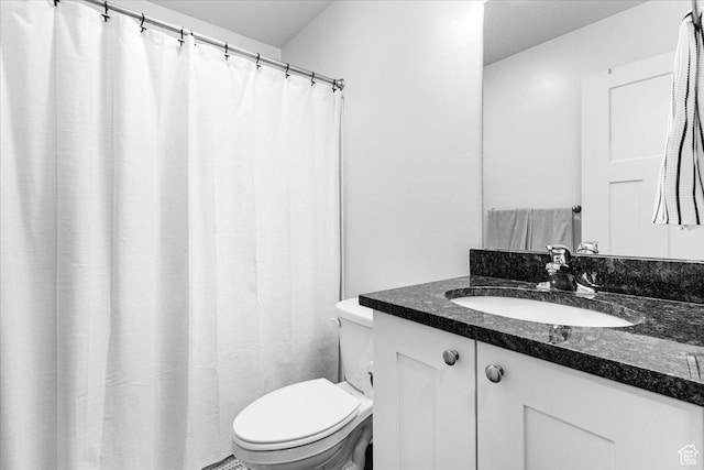 full bathroom with toilet and vanity