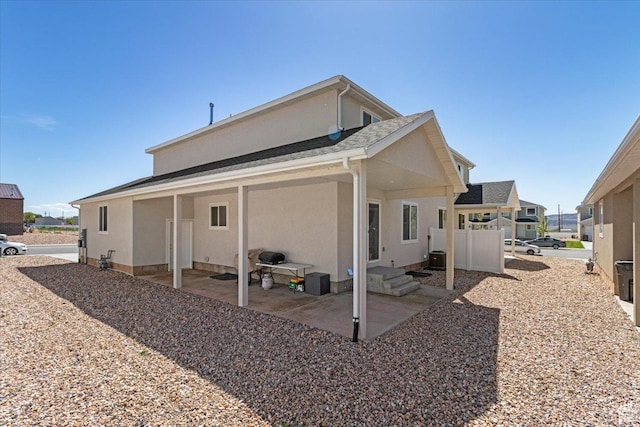 rear view of property with a patio and stucco siding