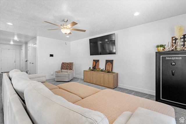 living area featuring carpet, baseboards, ceiling fan, recessed lighting, and a textured ceiling