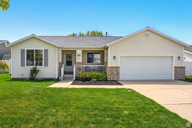 ranch-style home with brick siding, a porch, concrete driveway, a garage, and a front yard