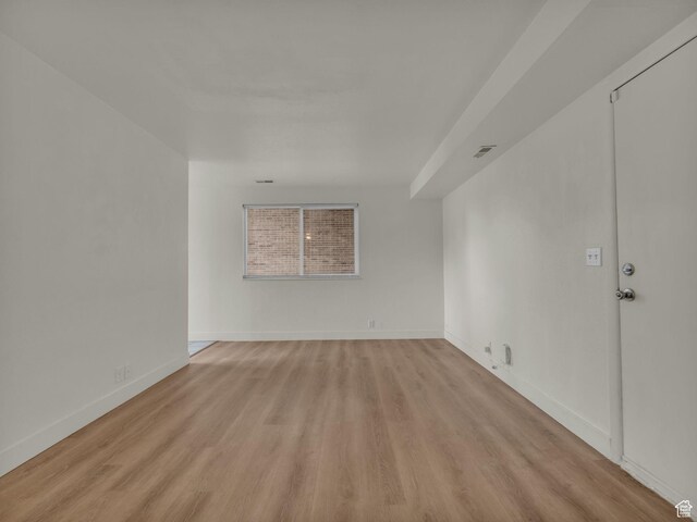unfurnished room featuring light wood-style floors and baseboards