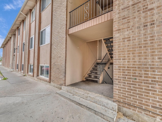view of exterior entry featuring brick siding