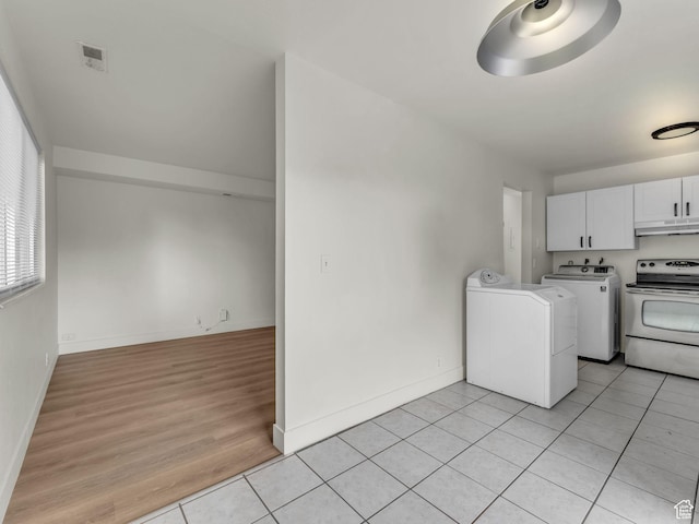 laundry area featuring light tile patterned flooring, baseboards, and independent washer and dryer
