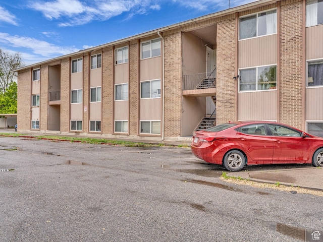 view of building exterior featuring uncovered parking