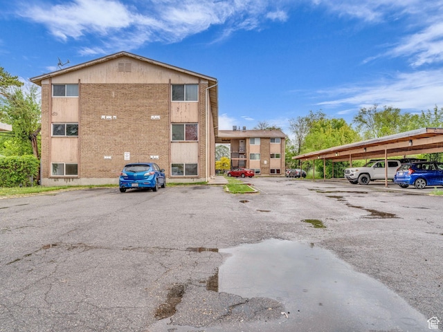 view of property with covered and uncovered parking