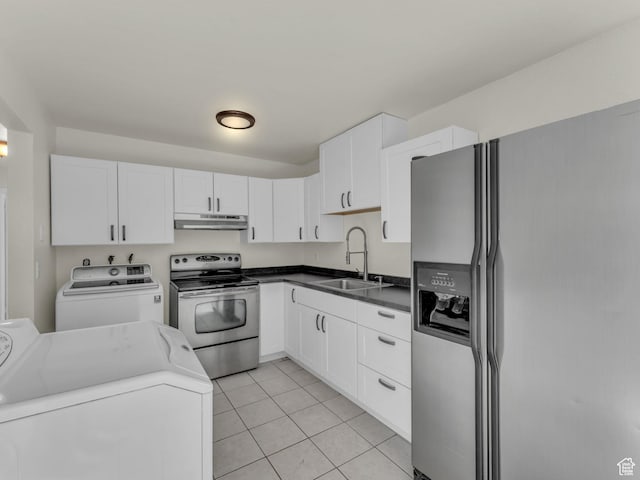 kitchen with stainless steel appliances, a sink, under cabinet range hood, washer and clothes dryer, and light tile patterned flooring