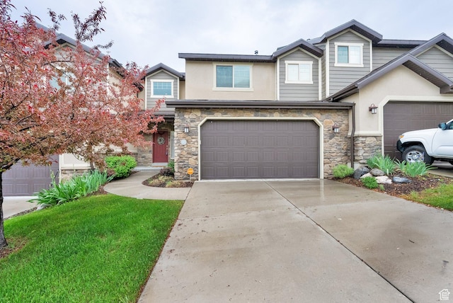 view of front of home featuring stone siding, stucco siding, concrete driveway, and an attached garage