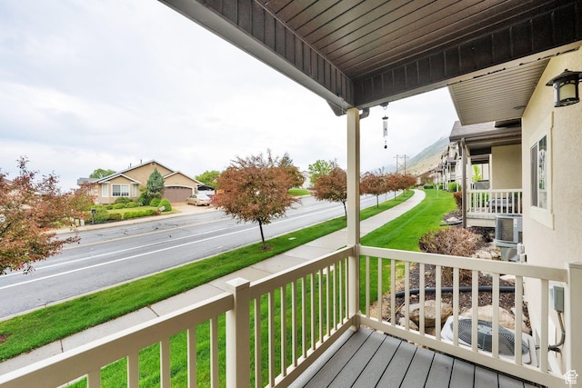 wooden deck featuring a lawn and a porch