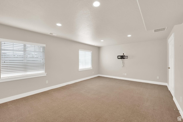 unfurnished room featuring recessed lighting, carpet, and baseboards