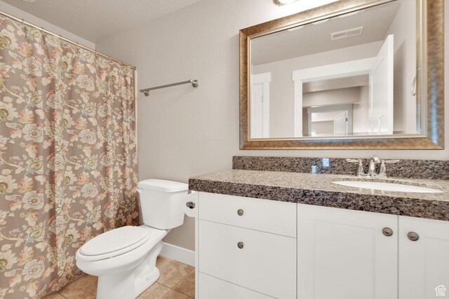 full bathroom with tile patterned floors, toilet, vanity, and curtained shower