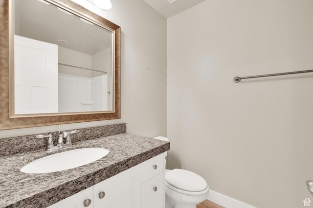 full bathroom with toilet, vanity, and a shower