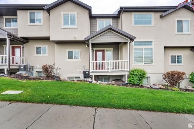 rear view of property featuring stucco siding and central AC unit
