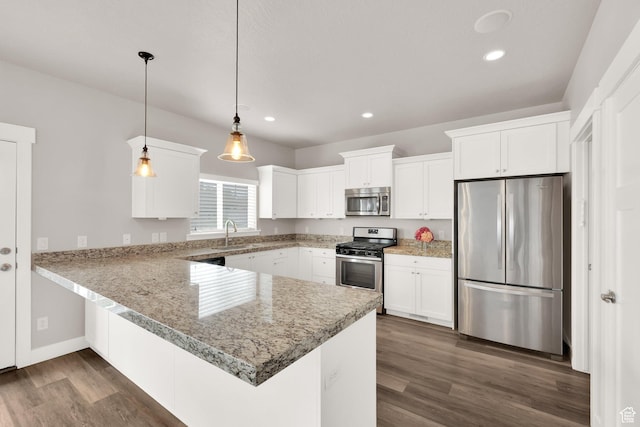 kitchen with appliances with stainless steel finishes, a peninsula, dark wood-type flooring, recessed lighting, and white cabinets