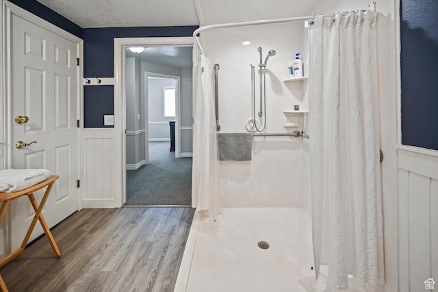 90 S Sherwood Dr, Providence, UT 84332 - bathroom with a stall shower, wood finished floors, and baseboards