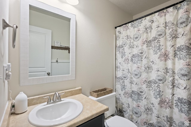 bathroom featuring vanity, toilet, and a shower with curtain