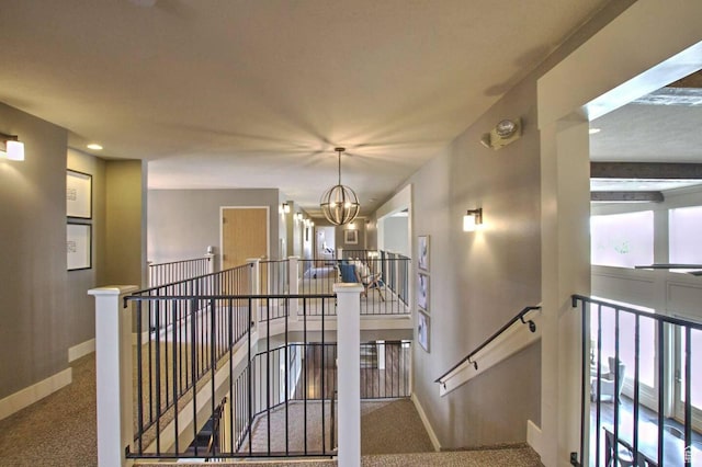 40 N Christa Cir, Garden City, UT 84028 - staircase featuring baseboards, carpet floors, and a chandelier