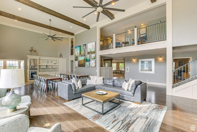 40 N Christa Cir, Garden City, UT 84028 - living area with a ceiling fan, a towering ceiling, beamed ceiling, wood finished floors, and plenty of natural light