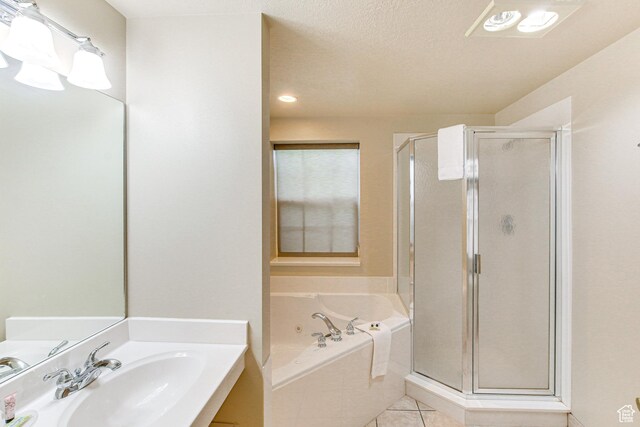 40 N Christa Cir, Garden City, UT 84028 - full bath featuring a sink, a shower stall, a garden tub, tile patterned floors, and a textured ceiling