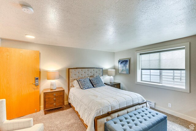 40 N Christa Cir, Garden City, UT 84028 - carpeted bedroom with a textured ceiling, baseboards, and a baseboard heating unit