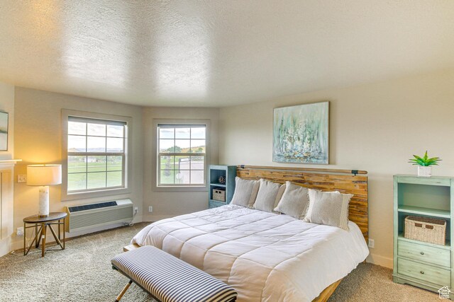40 N Christa Cir, Garden City, UT 84028 - bedroom featuring carpet, a wall mounted air conditioner, a textured ceiling, and baseboards