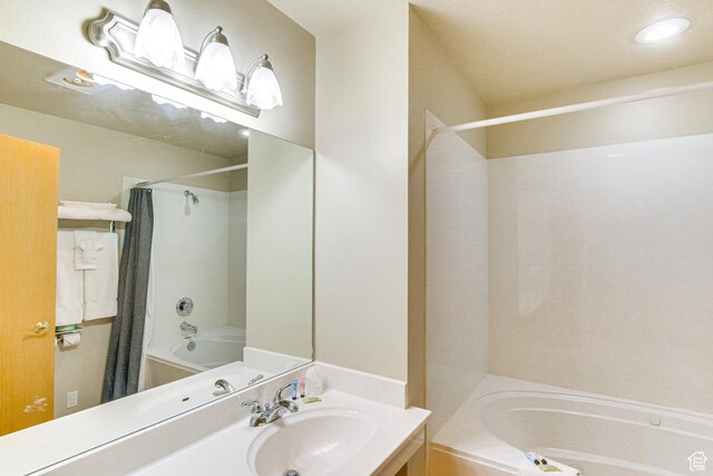 40 N Christa Cir, Garden City, UT 84028 - bathroom featuring shower / bath combo with shower curtain, vanity, and recessed lighting
