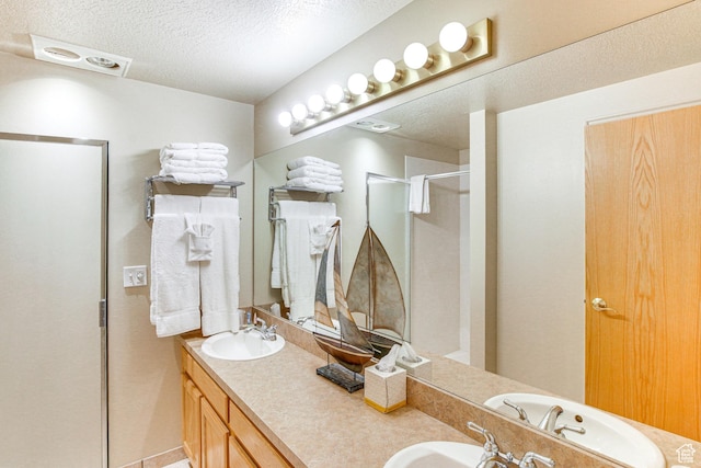 40 N Christa Cir, Garden City, UT 84028 - full bath featuring a textured ceiling, a stall shower, and double vanity