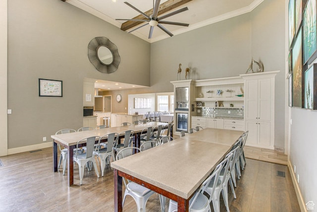40 N Christa Cir, Garden City, UT 84028 - kitchen featuring a towering ceiling, a ceiling fan, beverage cooler, white cabinets, and baseboards
