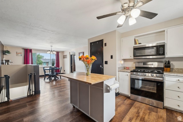 kitchen with stainless steel appliances, butcher block countertops, white cabinets, a chandelier, and dark wood finished floors