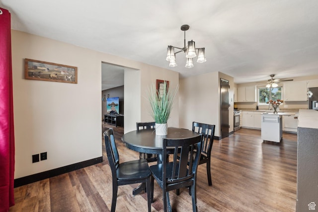 dining room with baseboards, dark wood finished floors, a chandelier, and a ceiling fan