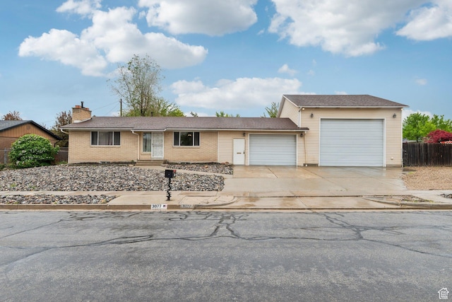 single story home with a garage, concrete driveway, fence, a chimney, and brick siding