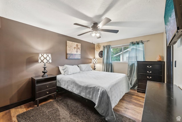bedroom with wood finished floors and ceiling fan