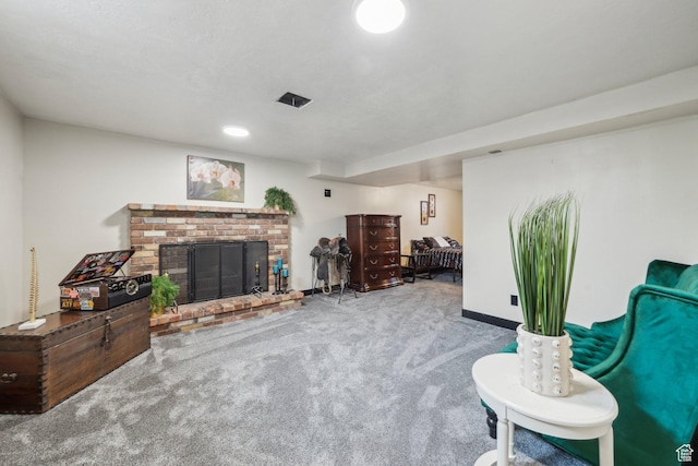 carpeted living room featuring a brick fireplace and baseboards