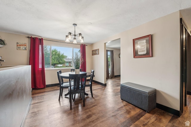 dining area featuring plenty of natural light, a chandelier, wood finished floors, and baseboards
