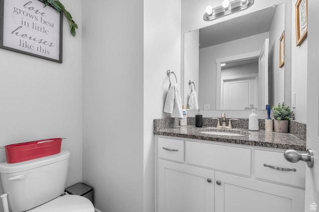 bathroom with toilet and vanity