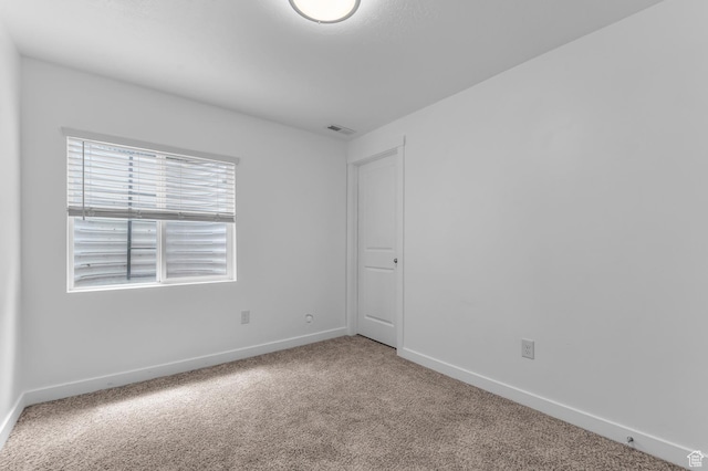 carpeted spare room with baseboards