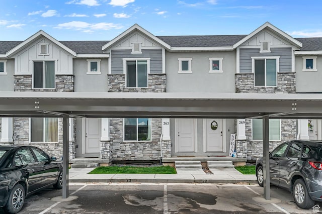 view of property with stone siding, covered parking, and board and batten siding