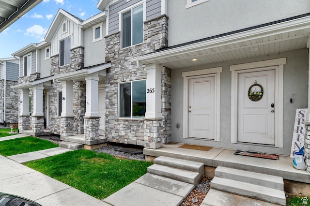 property entrance featuring stone siding and stucco siding