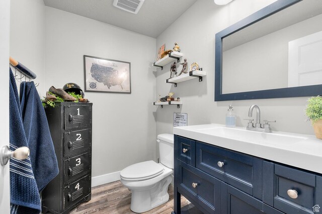 2546 N Wister Ln Unit 334, Lehi, UT 84043 - bathroom featuring wood finished floors, toilet, vanity, and baseboards