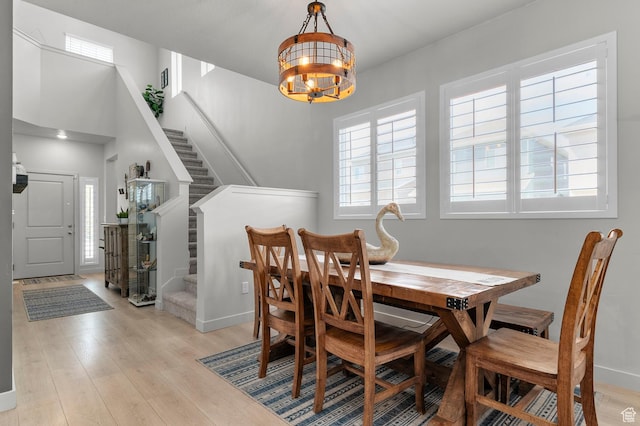 2546 N Wister Ln Unit 334, Lehi, UT 84043 - dining area with a chandelier, stairs, light wood-type flooring, and baseboards