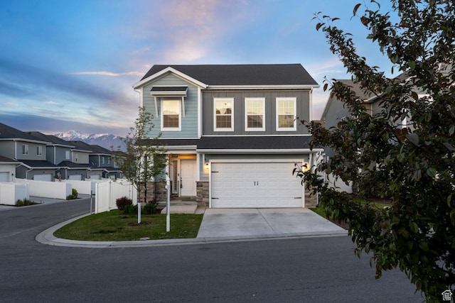 2546 N Wister Ln Unit 334, Lehi, UT 84043 - view of front of house featuring concrete driveway, a garage, fence, and stone siding