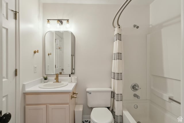 bathroom featuring toilet, shower / tub combo, and vanity