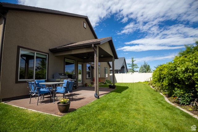 view of yard featuring a patio area and ceiling fan