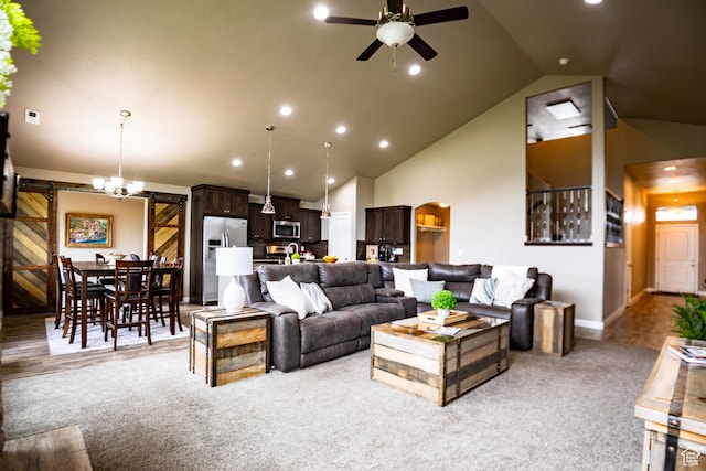 living room featuring a barn door, ceiling fan, light colored carpet, baseboards, and recessed lighting