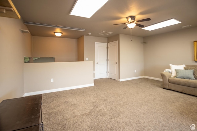 living area with ceiling fan, carpet floors, and baseboards