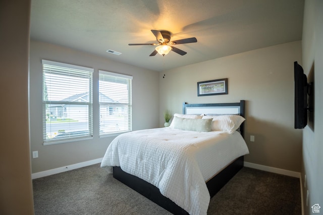 carpeted bedroom with baseboards and ceiling fan