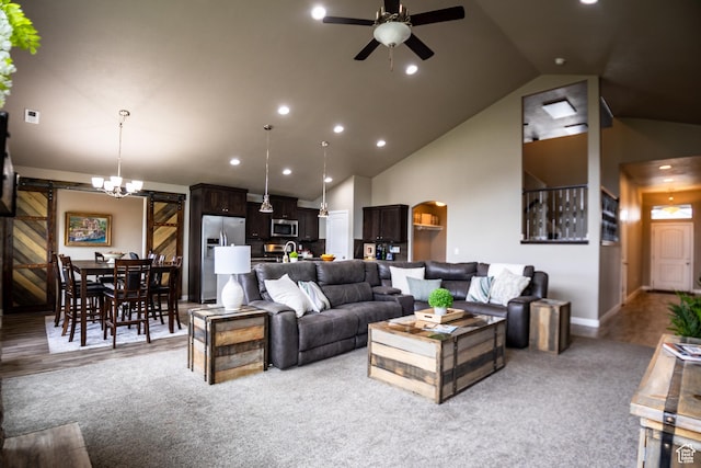 living room featuring a barn door, ceiling fan, light colored carpet, high vaulted ceiling, and recessed lighting
