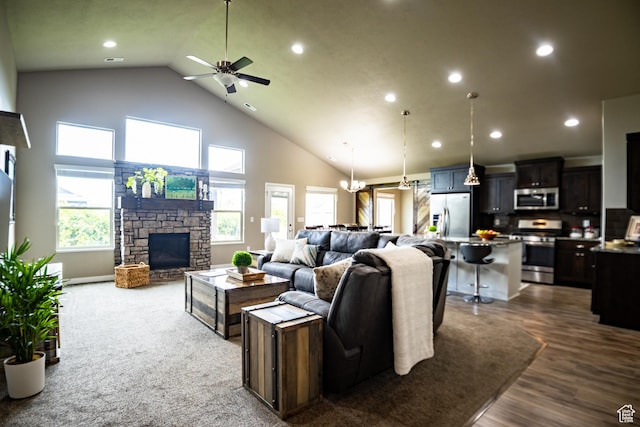 living area featuring high vaulted ceiling, a ceiling fan, a fireplace, recessed lighting, and dark wood finished floors