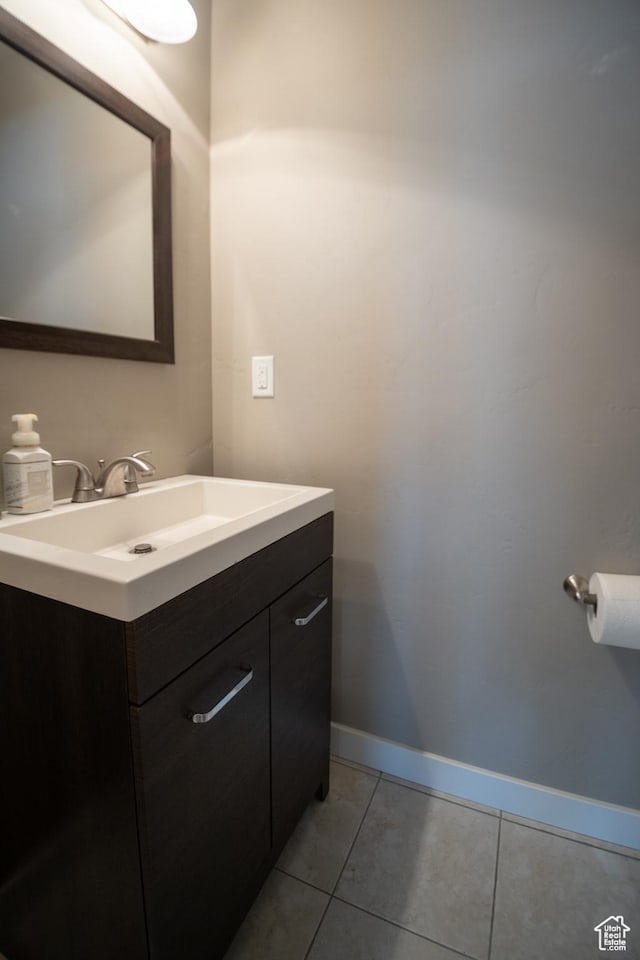 bathroom with tile patterned floors, vanity, and baseboards
