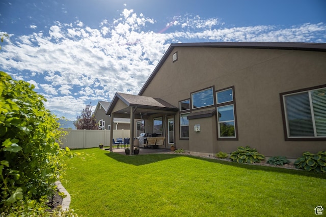 rear view of property with a patio and stucco siding
