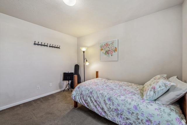 carpeted bedroom featuring baseboards